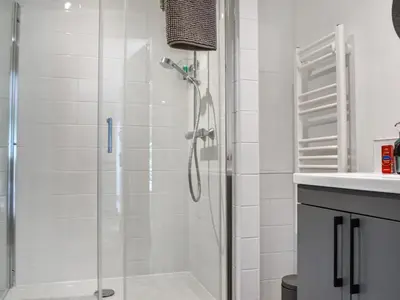 a bathroom with a shower and a sink at Roseland Roost - Uk49839 in Truro