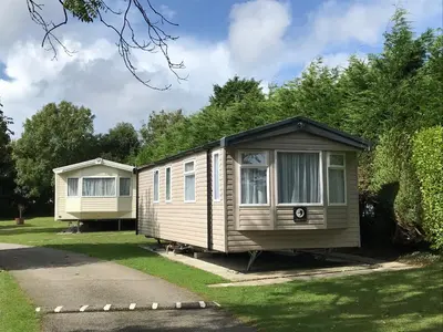 two mobile homes are parked in a yard at Trevarth Holiday Park in Chacewater