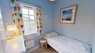 a small room with a bed and a window at C14 Gwelmore, Riviere Towans in Hayle