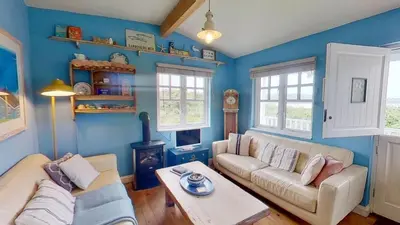 a living room with a couch and a table at C14 Gwelmore, Riviere Towans in Hayle