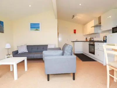 a living room with a couch and a kitchen at 161 Atlantic Bay Holiday Park in Padstow