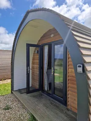 an arched entrance to a building with a toilet in it at Travellers Rest Glamping Pods & Shepherds Hut in Newquay