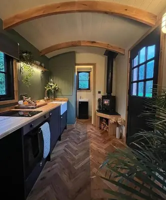 a kitchen with a sink and a counter top at Travellers Rest Glamping Pods & Shepherds Hut in Newquay