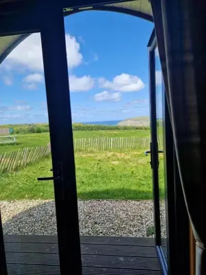 a view from a door looking out at a field at Travellers Rest Glamping Pods & Shepherds Hut in Newquay