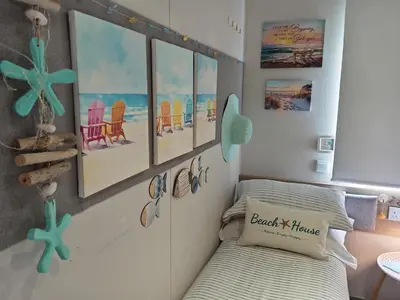 a bedroom with a bed and some pictures on the wall at Newquay Bay Resort - Poppy's Lodge Retreat in Newquay