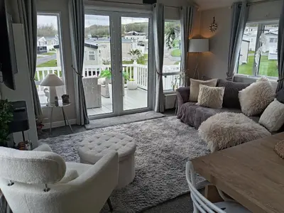 a living room with a couch and chairs and a table at Newquay Bay Resort - Poppy's Lodge Retreat in Newquay
