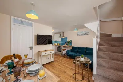 a living room with a couch and a table at Perfect place for family time in Hayle