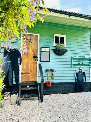 a blue house with a door and a window at Hillhead Hideaway in Saint Columb Major