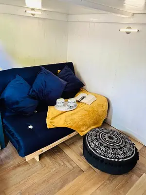 a small bed in a small room with a pillow at Hillhead Hideaway in Saint Columb Major
