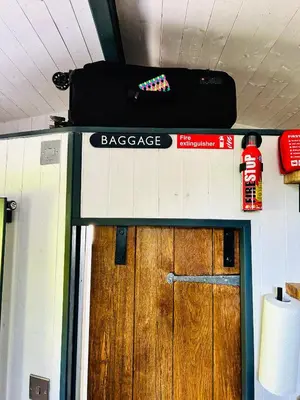 a door with a baggage sign on top of it at Hillhead Hideaway in Saint Columb Major