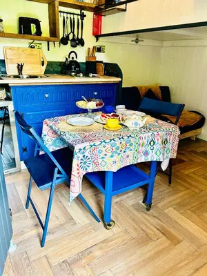 a blue table with a table cloth on it in a kitchen at Hillhead Hideaway in Saint Columb Major