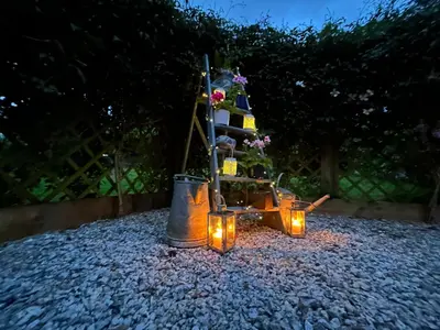 a christmas tree in a pot with lights at Hillhead Hideaway in Saint Columb Major