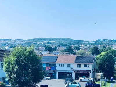 a town with cars parked in a parking lot at Holm Cottage near Charlestown in St Austell