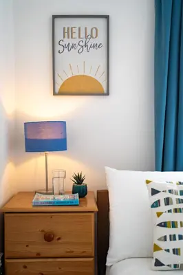 a bedroom with a bed and a table with a lamp at Peaceful - 10-min walk to beach - The White House in Falmouth