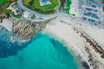 an aerial view of a beach and the ocean at Peaceful - 10-min walk to beach - The White House in Falmouth