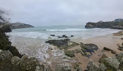 a beach with rocks and the ocean at Bell Tent 1 in St Austell