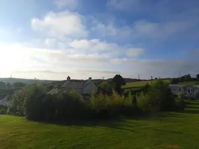 a house on a hill with a green field at The Cabin in St Austell