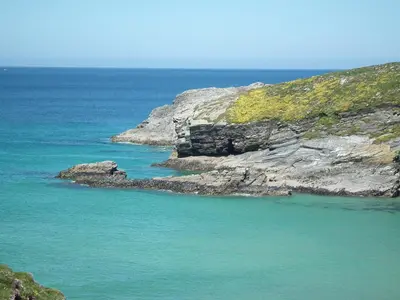 a group of rocks in the water next to the ocean at Glendorgal Sands - The best sea views in Cornwall in Saint Columb Minor