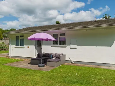 a purple umbrella sitting in front of a house at Chalet The Birches by Interhome in Liskeard
