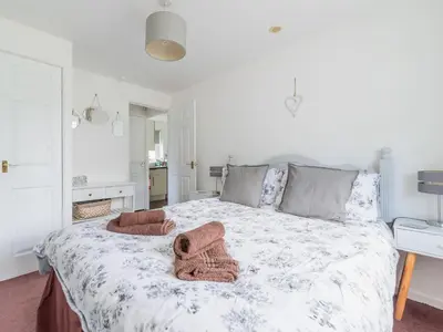 a bedroom with a bed with two towels on it at Chalet The Birches by Interhome in Liskeard
