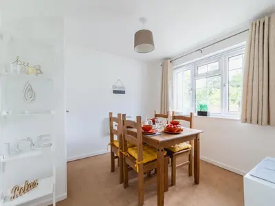 a kitchen and dining room with a wooden table and chairs at Chalet Rosecraddoc Lodges by Interhome in Liskeard