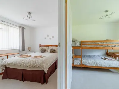 a bedroom with a bed and a bunk bed at Chalet Rosecraddoc Lodges by Interhome in Liskeard