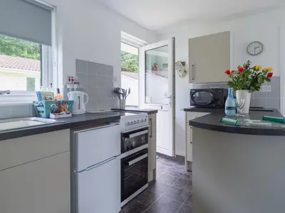 a kitchen with a sink and a stove top oven at Chalet Rosecraddoc Lodges by Interhome in Liskeard