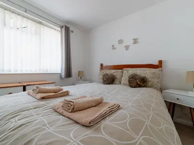 a bedroom with a large bed with towels on it at Chalet Rosecraddoc Lodges by Interhome in Liskeard