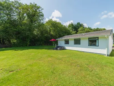 a house with a large yard in front of it at Chalet Rosecraddoc Lodges by Interhome in Liskeard