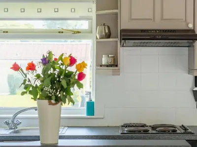a vase of flowers sitting on a kitchen sink at Chalet Bliss by Interhome in Liskeard