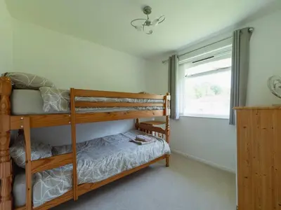a bedroom with two bunk beds and a window at Chalet Bliss by Interhome in Liskeard