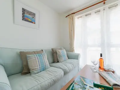 a living room with a couch and a table at Chalet Bliss by Interhome in Liskeard