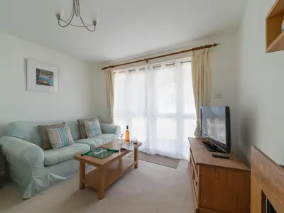 a living room with a couch and a tv at Chalet Bliss by Interhome in Liskeard