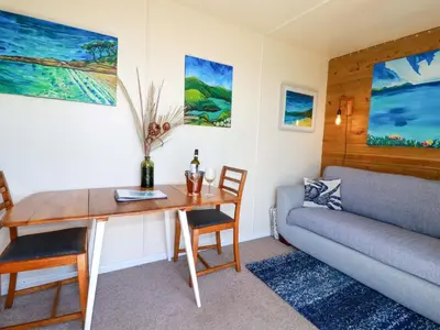 a living room with a table and a couch at The Studio in Truro