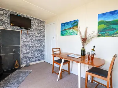 a dining room with a wooden table and chairs at The Studio in Truro