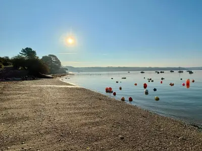 a beach with orange buoys in the water at The Studio in Truro