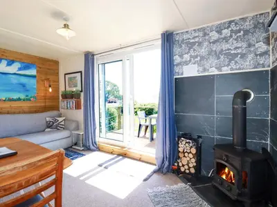 a living room with a wood stove at The Studio in Truro