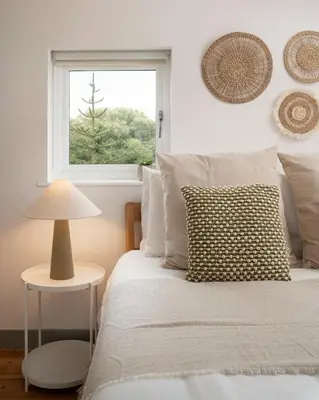 a white bedroom with a bed and a window at Naut Retreat - Idyllic hideaway with hot tub, gym & gamesroom ideally located in Zennor near St Ives in Penzance