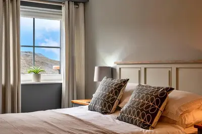a bedroom with a bed with a window at Finest Retreats - 25 The Waves in Porth