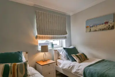 a small bedroom with two beds and a window at Finest Retreats - 25 The Waves in Porth