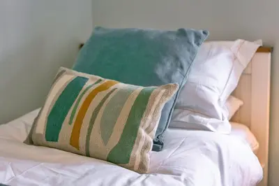 a pillow sitting on top of a bed at Finest Retreats - 25 The Waves in Porth