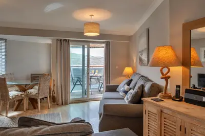 a living room with a couch and a table at Finest Retreats - 25 The Waves in Porth