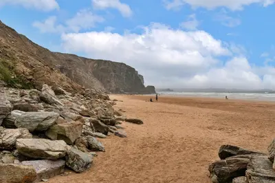 a beach with a bunch of rocks on it at Finest Retreats - 25 The Waves in Porth