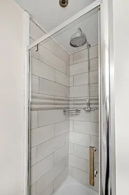 a shower with a glass door in a bathroom at Finest Retreats - Farleigh Cottage in Looe