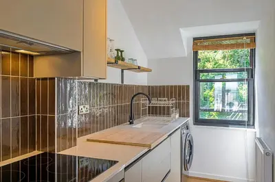 a kitchen with a sink and a window at Finest Retreats - Williams Court in Falmouth