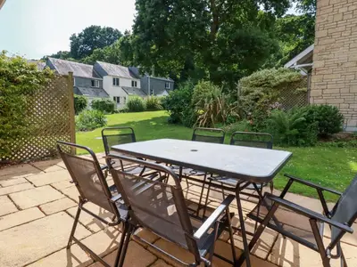 a table and chairs sitting on a patio at Trouts Reach in Falmouth