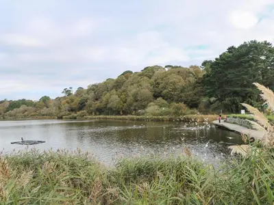 a boat on a lake in a park at Trouts Reach in Falmouth