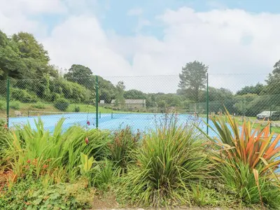 a swimming pool in a park with plants at Trouts Reach in Falmouth