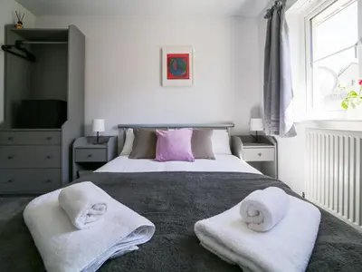a bedroom with a bed with towels on it at Canyke Fields in Bodmin