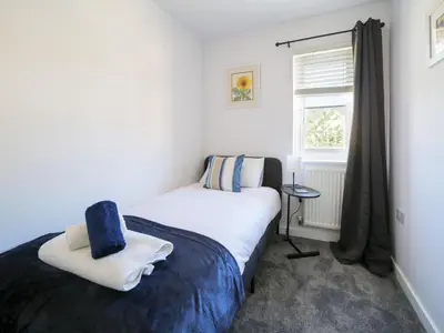 a small bedroom with a bed and a window at Canyke Fields in Bodmin